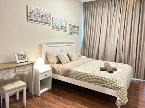 a bedroom with a bed with a desk and a chair at Jeff & Ricky Homestay 82@Vivacity Megamall in Kuching