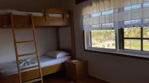 a bedroom with two bunk beds and a window at Ana Rest House Hostel Berat in Berat