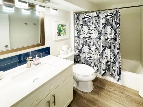 a bathroom with a toilet and a shower curtain at Waikiki Ilikai Marina in Honolulu