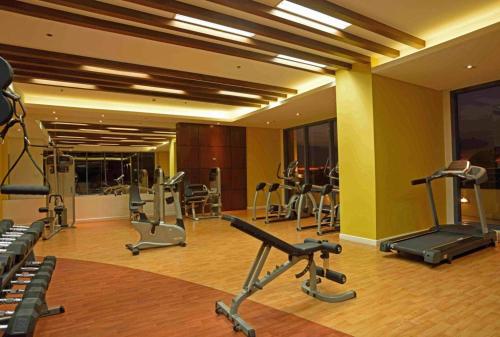 a gym with several exercise equipment in a room at Cozy Condo near US EmbassyErmita Manila/ Roxas blvd/ Dolomite beach in Manila