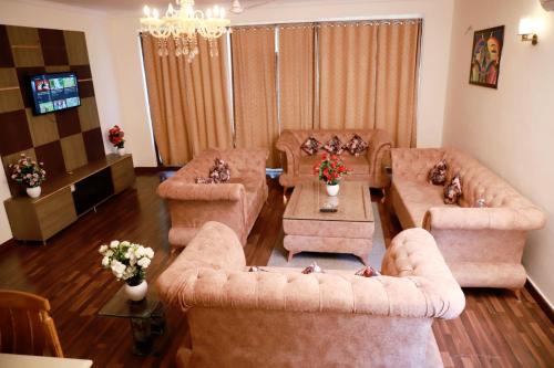 a living room with two couches and a tv at Divine India Service Apartment 2Bhk, 2A Saket in New Delhi