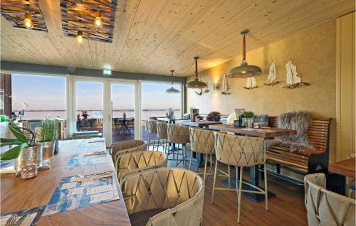 a restaurant with chairs and a bar with a view at Nice Apartment In Lembruchdümmer See in Lembruch