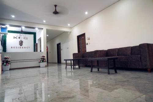 a living room with a couch and a table at KCG Residency in Mysore