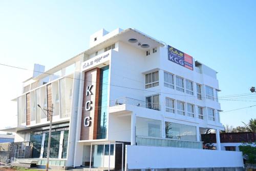 a white building with a sign on it at KCG Residency in Mysore