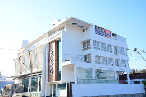 a white building with a sign on it at KCG Residency in Mysore