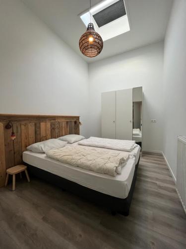 a bedroom with a large bed in a room at Penthouse DeLuxe in Oostkapelle