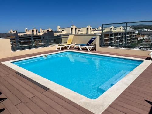 a swimming pool on the roof of a building at Olhão Marina Village in Olhão