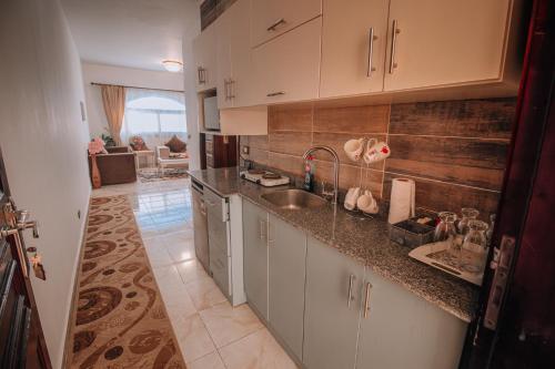 a kitchen with a sink and a counter top at Swiss Royal DAHAB in Dahab