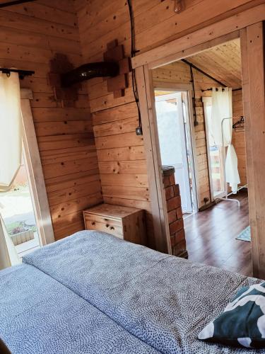 a bedroom in a log cabin with a bed at Agroturystyka Jeleń in Jeleń