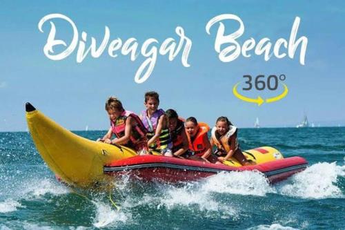 a group of people riding a banana boat in the ocean at Sandcastle Cottages 2 AC - WiFi - SmartTV - Parking - Diveagar in Diveagar