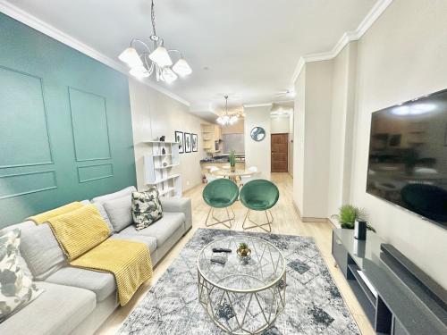 a living room with a couch and a table at Elegant Emerald King Size 2 Bed Apartment - Free Parking - Free Wifi in Durban