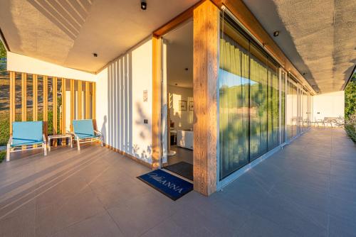 a lobby of a building with two chairs and windows at Villa Anna, Luxury and private pool in Alba
