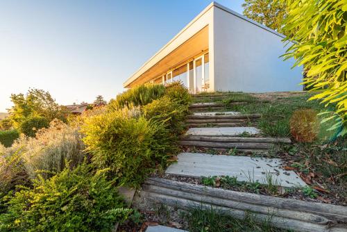 a house on a hill with stairs in front of it at Villa Anna, Luxury and private pool in Alba