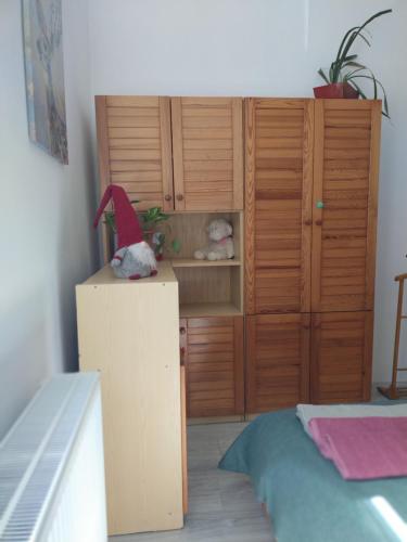 a room with a wooden cabinet with a teddy bear on top at Old Buda Family Home in Budapest