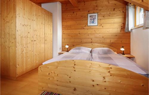 a wooden bedroom with a bed in a wooden wall at Stunning Home In Steinfeld With Wifi in Steinfeld