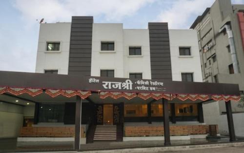 a building with a sign on the front of it at Hotel Rajshree in Ahmadnagar