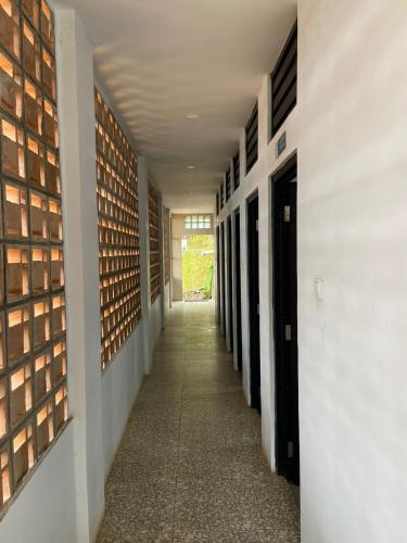 a hallway of a building with a long corridor at De Pointé Resort & Resto in Campaka
