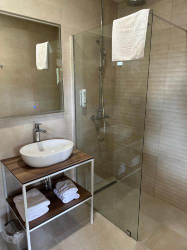 a bathroom with a sink and a shower at Bungalows SPORT CENTAR in Međugorje