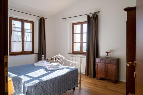 Ένα ή περισσότερα κρεβάτια σε δωμάτιο στο Podere Montale Il Borgo