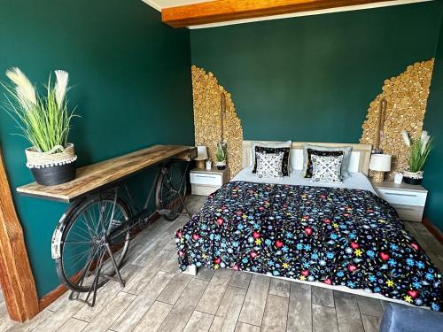 a bedroom with a bed and a bicycle in it at Kaszubskie Zacisze in Chmielno