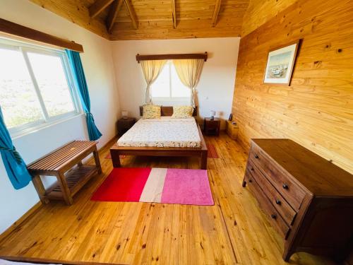 ein Schlafzimmer mit einem Bett und einer Bank in einem Zimmer in der Unterkunft Kokoa Sands - Ankasy Madagascar in Tsiandamba