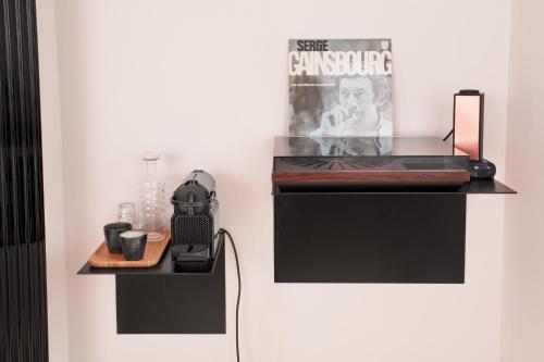 a room with a black shelf with a phone and a magazine at B&B Lucy in the Sky in Antwerp