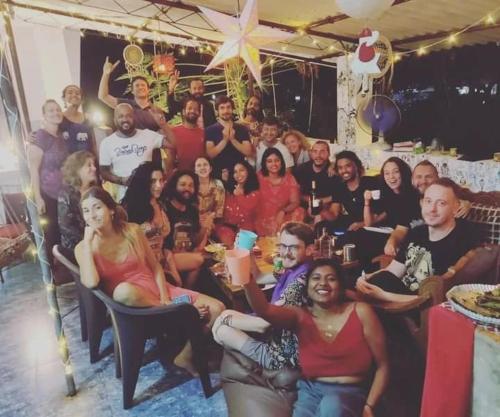 a group of people posing for a picture at a party at Dreamcatcher House & Hostel at Arambol Beach in Arambol