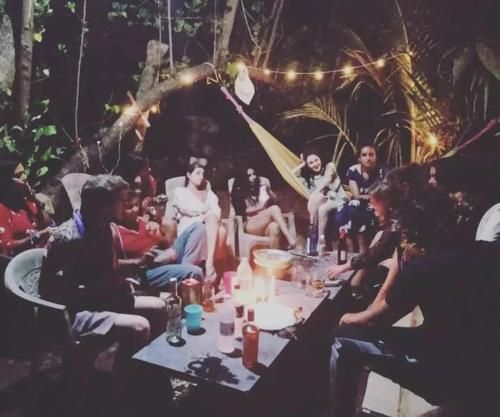 a group of people sitting around a table at Dreamcatcher House & Hostel at Arambol Beach in Arambol