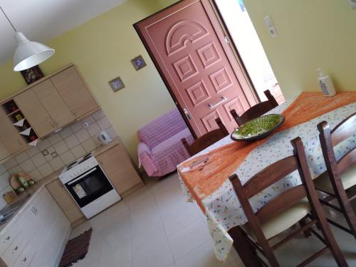 a kitchen and dining room with a table and a door at DREAMY SOUTH in Frangokastello
