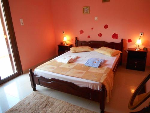 a bedroom with a large bed with red walls at DREAMY SOUTH in Frangokastello