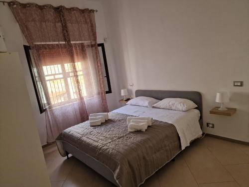 Postel nebo postele na pokoji v ubytování Casa Poseidonia - intero alloggio in riva al mare