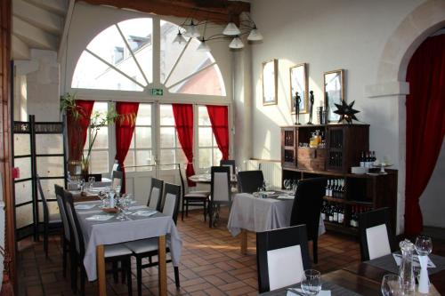 restauracja ze stołami i krzesłami oraz dużym oknem w obiekcie Terre de Brenne w mieście Azay-le-Ferron