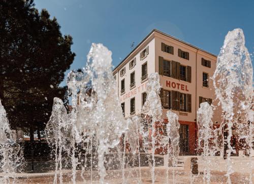 a water fountain in front of a hotel at Mage hôtels - HÔTEL LA GRENETTE in Roanne