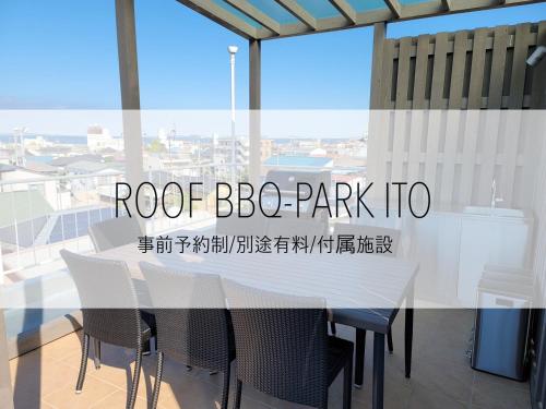 a white table and chairs in a room with a window at Smart Stay Ito 201 in Ito