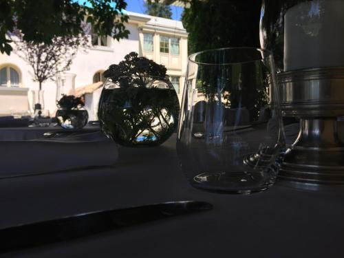 a table with two glass vases sitting on top of it at Villa Orso Grigio in Ronzone