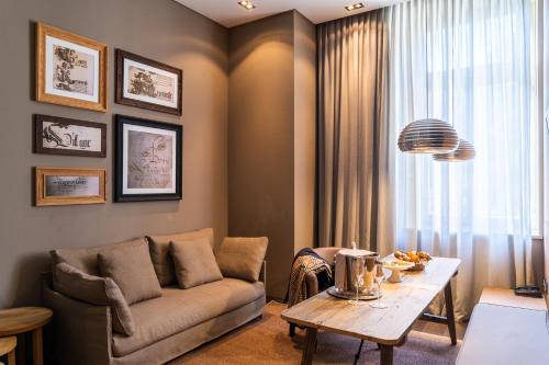a living room with a couch and a table at Grand Hotel Billia in Saint Vincent
