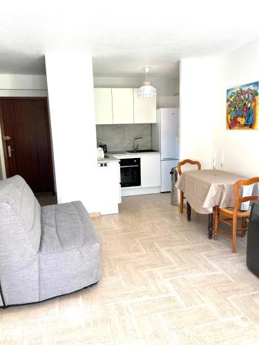 un salon avec un canapé et une table dans l'établissement Appartement Cosy Piscine Mandelieu, à Mandelieu-la-Napoule