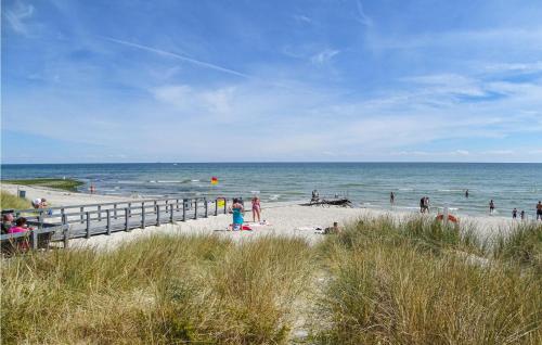 a group of people on a beach near the ocean at Holiday Home Aspevej Grenaa X in Grenå
