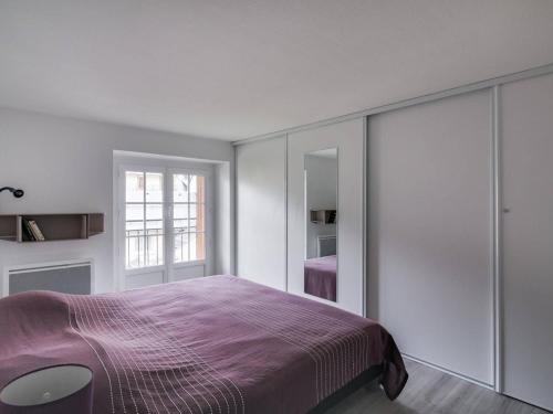 une chambre avec un lit violet et une fenêtre dans l'établissement Duplex T3 pour 6 personnes avec balcon - Centre de Cauterets, à 300m des pistes - FR-1-401-49, à Cauterets