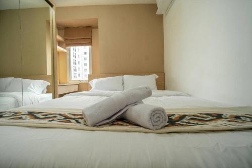 Кровать или кровати в номере Premium 2BR @ Bassura City East Jakarta