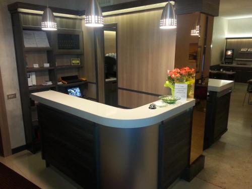 a kitchen with a refrigerator and a counter top at Hotel Garden in Milan