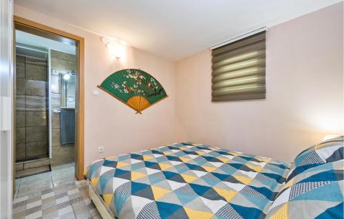 a bedroom with a bed and a painting on the wall at Nice Home In Breznicki Hum With House A Panoramic View in Hrašćina