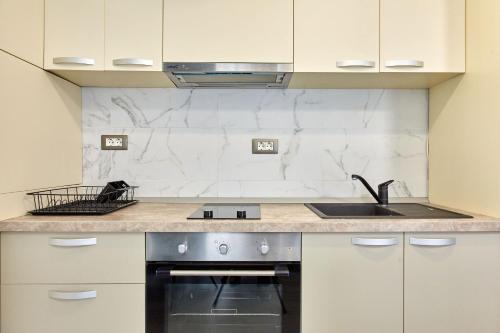 a kitchen with a sink and a stove at Studio Melody Nord 10 in Năvodari