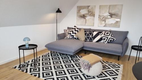 a living room with a couch and a rug at Haus Polarstern Ferienwohnung Kapella in Borkum