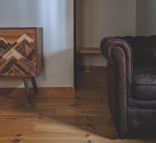 a living room with a chair and a table at Tetxe B&B Roncal in Roncal