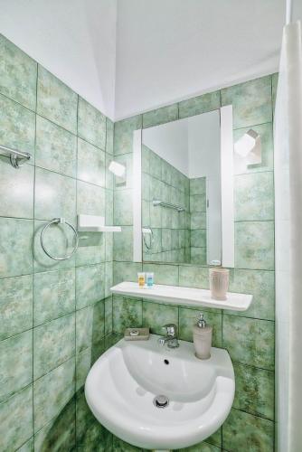 a bathroom with a sink and a mirror at Pavlos Place in Antiparos Town