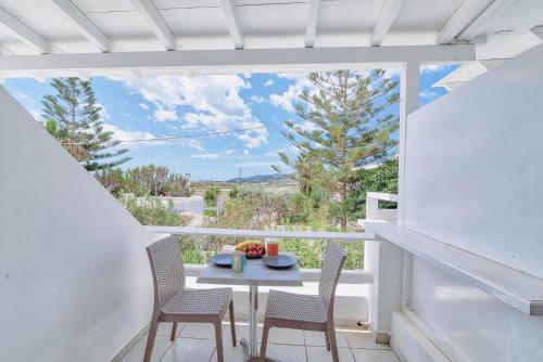 a table and chairs on a balcony with a view at Pavlos Place in Antiparos Town