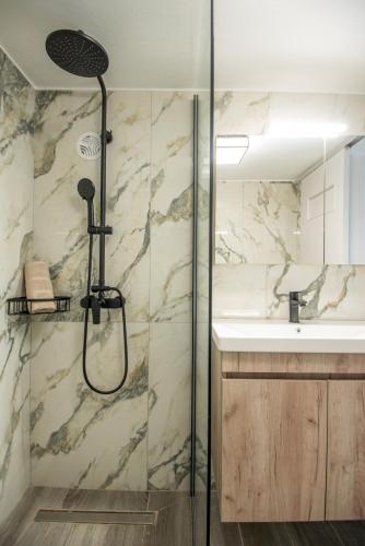 a bathroom with a shower and a sink at Nicolas Exclusive Apartment in Agios Nikolaos