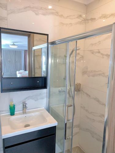 a bathroom with a sink and a shower at For Rest Aparthotel in St Paul's Bay