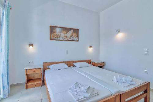 a bedroom with a bed and a picture on the wall at Pavlos Place in Antiparos Town